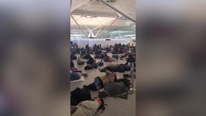 Travel chaos: Passengers forced to sleep in Stansted airport as flights remain grounded by snow