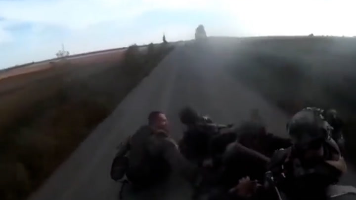 Moment armoured vehicle carrying fleeing Russian soldiers flips over on road