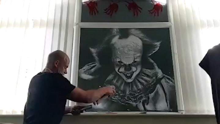 Father creates Pennywise mural for Halloween using snow spray