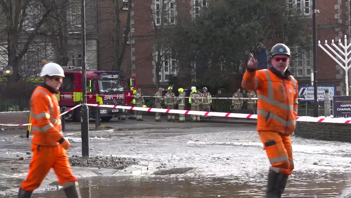 Burst water main floods London street