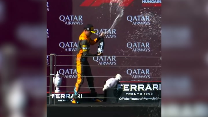 Lando Norris smashes Grand Prix trophy during podium celebration