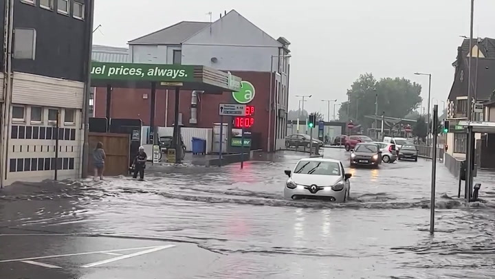 Cars caught in heavy flooding in Wales