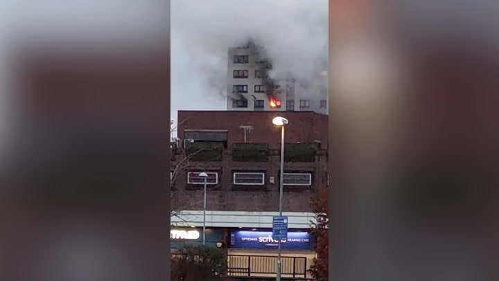 Flames and smoke billow from window after fire breaks out at Salford tower block