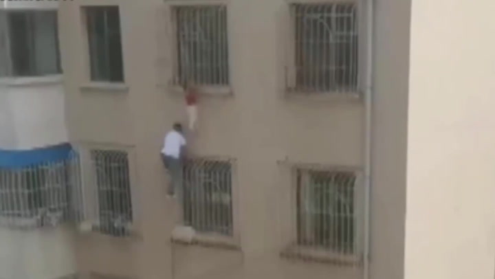 Man climbs wall to save toddler from a sixth-floor window in China