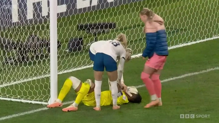 England players console Nigeria goalkeeper after winning on penalties