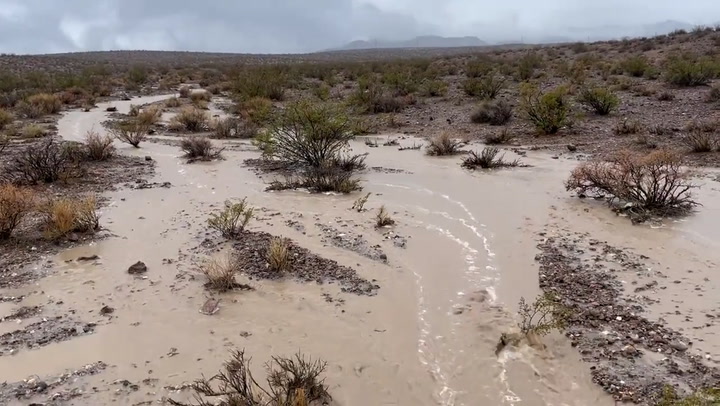 Floodwater rushes through the Mojave Desert