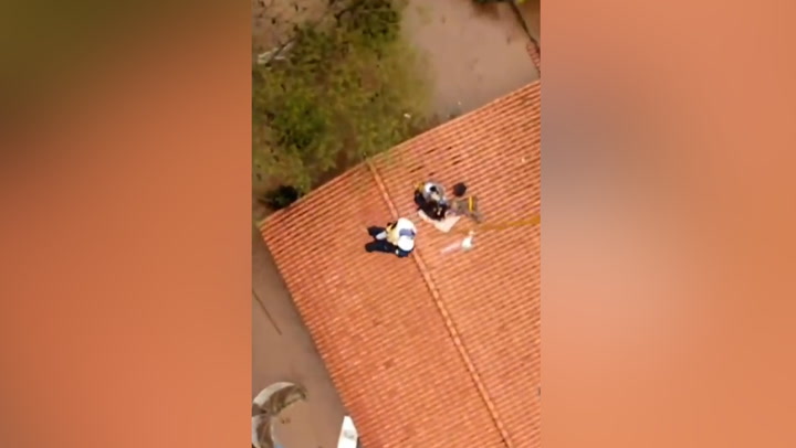 Toddler rescued from roof of flooded home in Brazil