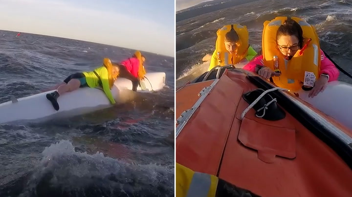 Rowers cling to bottom of boat after it capsizes in North Sea