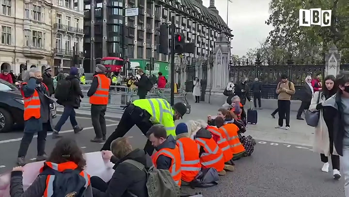 Insulate Britain protesters glue hands to road outside parliament