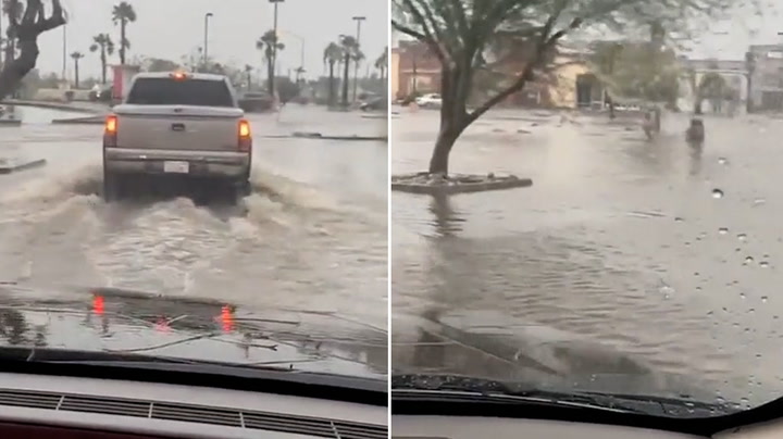Cars drive through floodwater after Hurricane Hilary makes landfall in California
