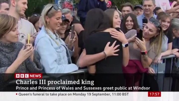 Duchess of Sussex hugs young girl at Windsor castle walkabout