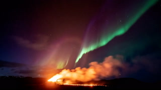 Stunning Northern Lights shine over Iceland’s erupting volcano