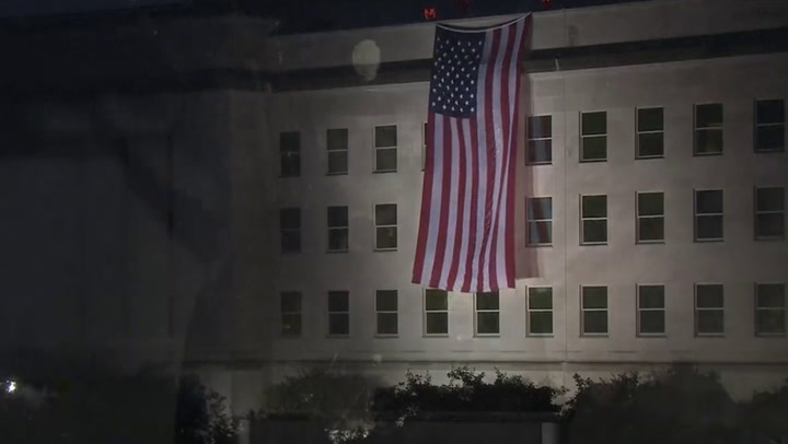 US flag is unfurled from the Pentagon roof to mark 9/11 attacks