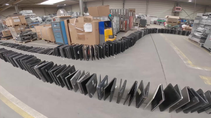 Tech team breaks world record for biggest domino chain of laptops