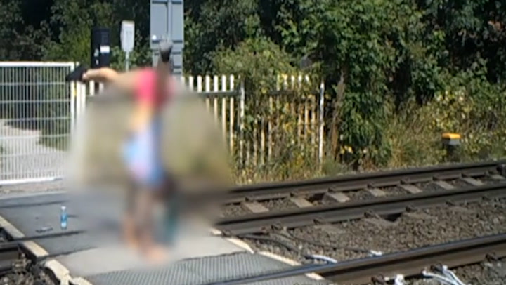 CCTV footage shows teenagers doing handstands at level crossing