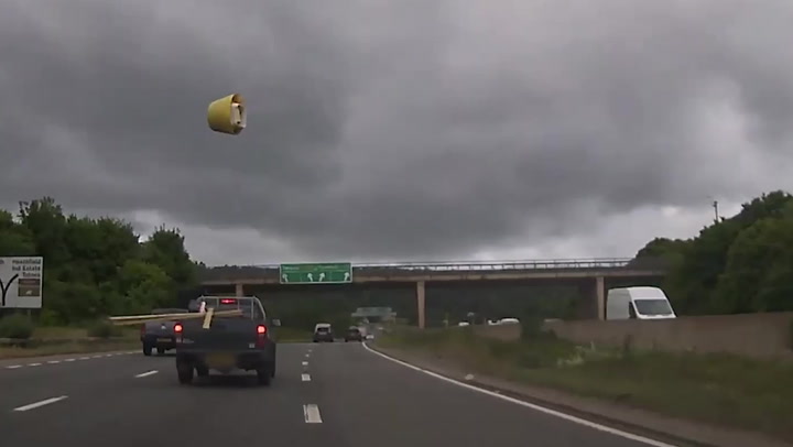 Moment car avoids bucket catapulted into air on motorway in freak accident