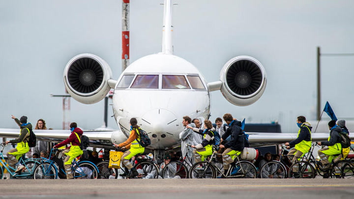 Climate activists cause chaos on bikes as they cycle on runway of Amsterdam airport