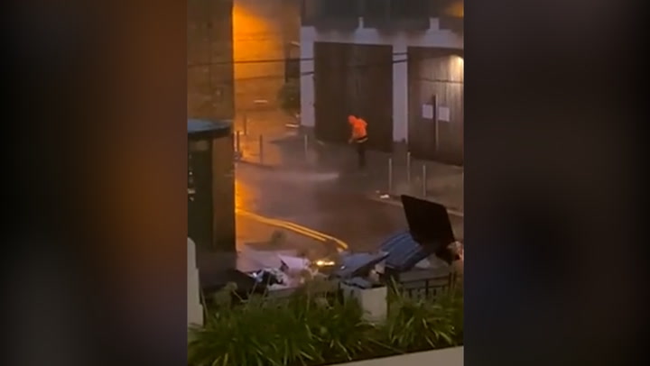 Man washes paths in incredibly heavy rain during Storm Barra