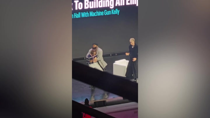 Man interrupts Machine Gun Kelly talk before being hauled off stage by security