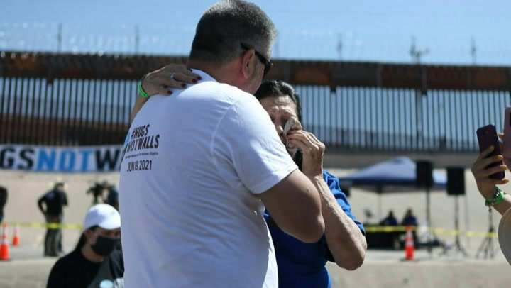 At the US-Mexico border relatives hug during annual event postponed due to the pandemic