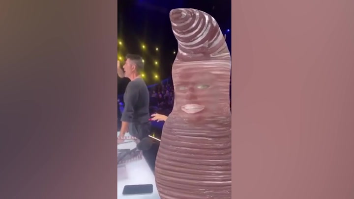 Heidi Klum turns fellow America's Got Talent judge Simon Cowell into her Halloween worm costume