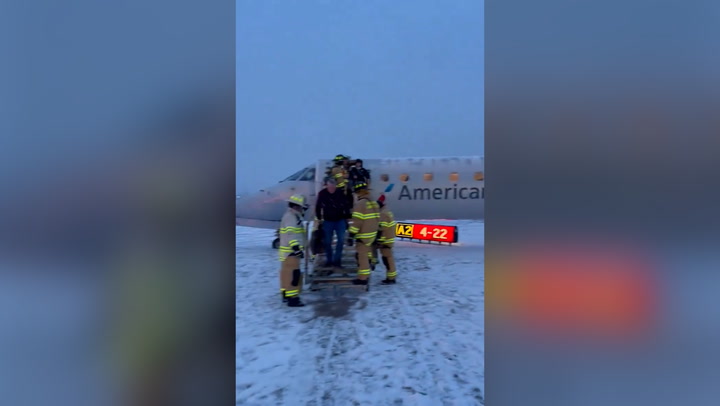 American Airlines plane carrying 53 passengers skids off icy New York airport runway
