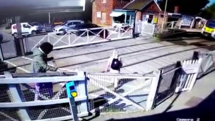 Pedestrians in near miss with train at level crossing after jumping locked barriers
