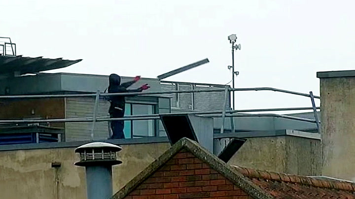 Teenagers 'throw planks of wood' onto street after climbing onto roof of derelict shop