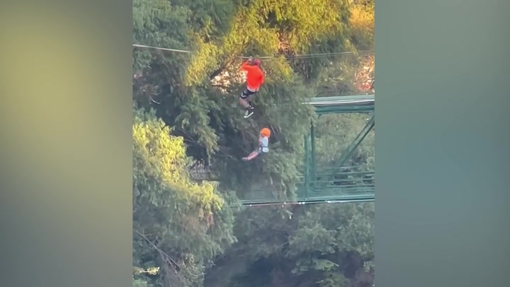 Terrifying moment six-year-old falls from zipline into lake