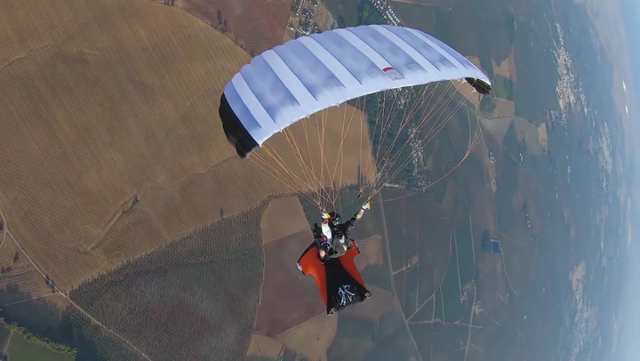 Skydiver rides wingsuit pilot in spectacular aerial stunt