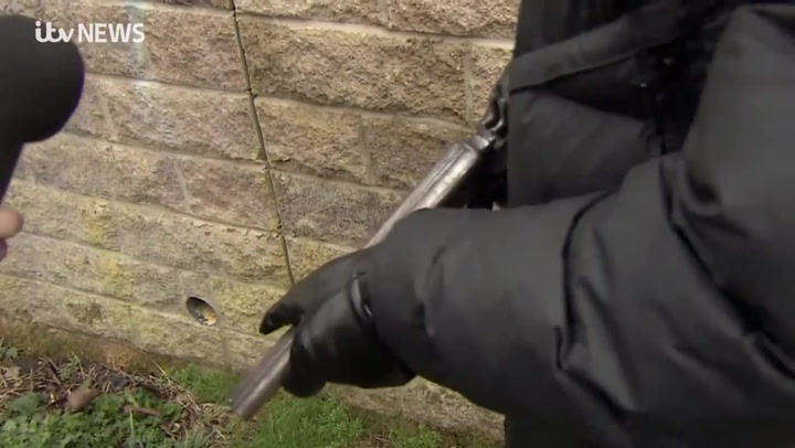 Masked man pulls out loaded gun during interview with ITV News