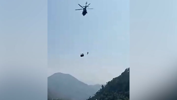 Rescue helicopter battles to save stricken cable car in Pakistan