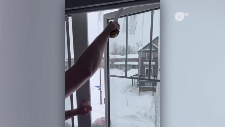 ICICLE SURGERY WITH A MACHETE AFTER MAJOR WINTER STORM