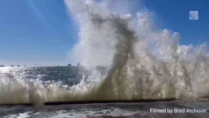 LARGE WAVES CRASH ALONG VANCOUVER'S SEAWALL AT HIGH TIDE