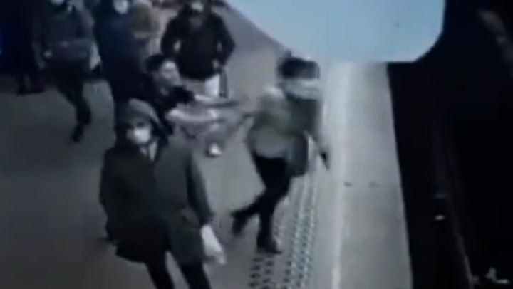 Man pushes woman off platform in front of oncoming train 