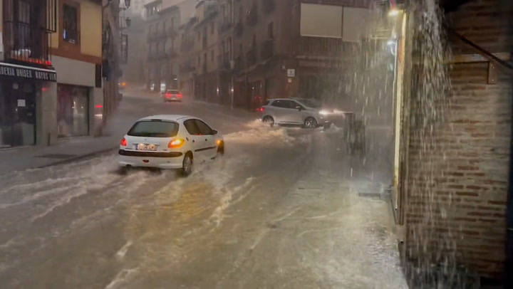 Water cascades down streets of Toledo in Spain