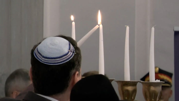 Moment Polish parliament relights Hanukkah candles extinguished by far-right politician