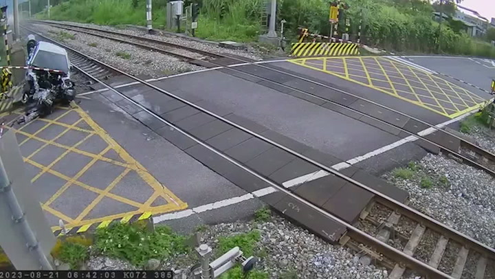 Shocking moment drunk driver crashes into speeding train at level crossing in Taiwan