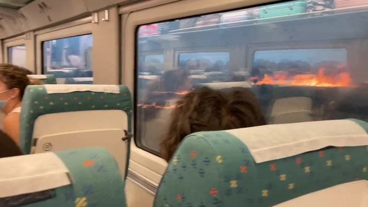 Wildfires surround paused train in Spain