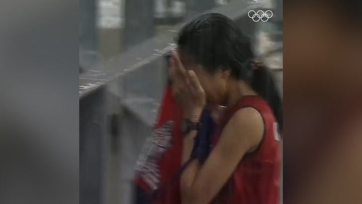 Cambodian woman Bou Samnang finishes 5000m race in pouring rain