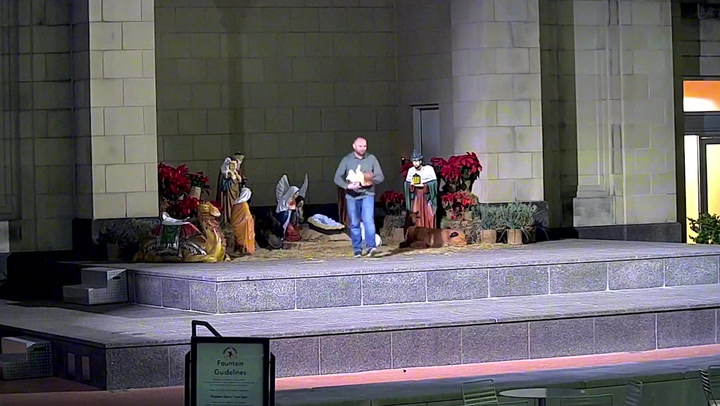 Moment man takes baby Jesus from Nativity scene
