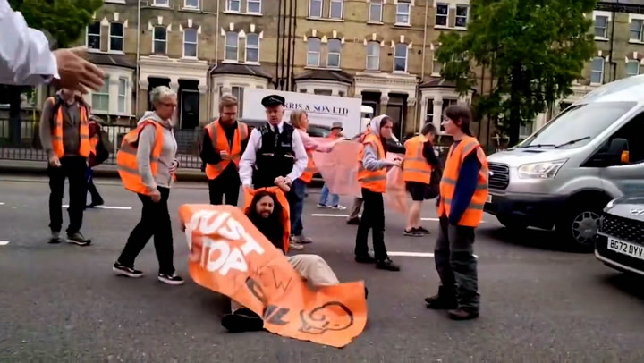 Police drag Just Stop Oil activists along road after blocking traffic