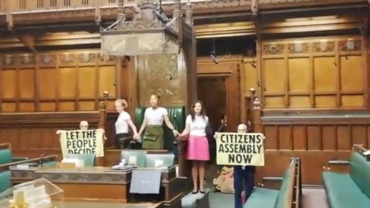 Extinction Rebellion activists glue themselves to speaker's chair in House of Commons