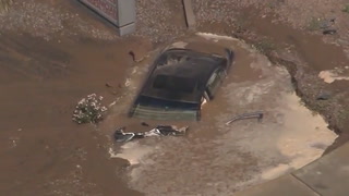 Muddy sinkhole swallows car in Phoenix after crash