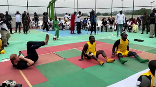 Harry plays sitting volleyball as Meghan cheers him on in Nigeria