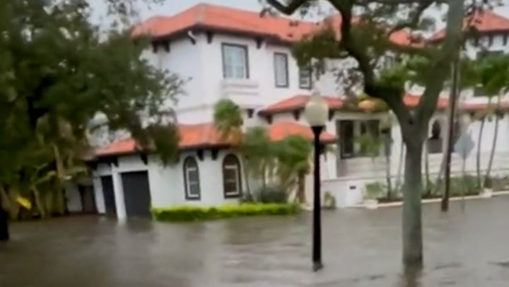 Floodwater rushes down Tampa street after Hurricane Idalia makes Florida landfall