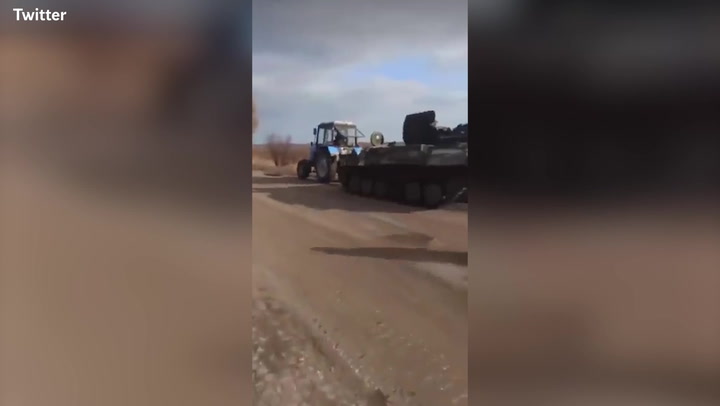 Russian soldier chases Ukrainian farmer appearing to tow his tank away with tractor
