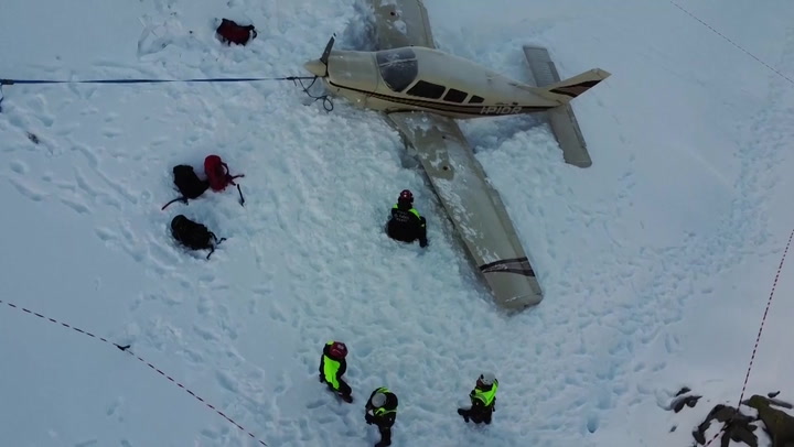 Pilot and passengers rescued after plane makes emergency landing on mountain