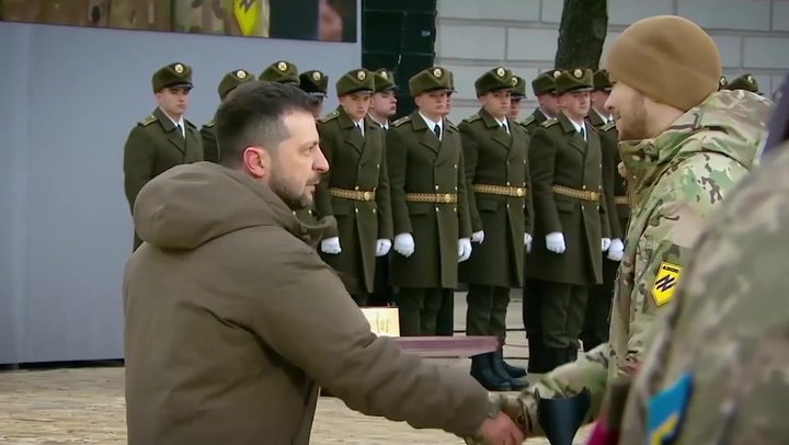 Zelensky marks anniversary of invasion by presenting medals to Ukrainian fighters
