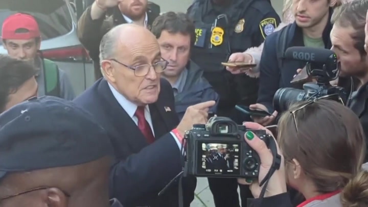 Rudy Giuliani leaves court after being ordered to pay $148 million to election workers